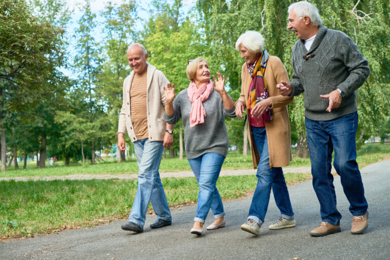 Senior friends out for a walk, enjoying the outdoors