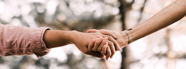 A close-up view of two hands holding