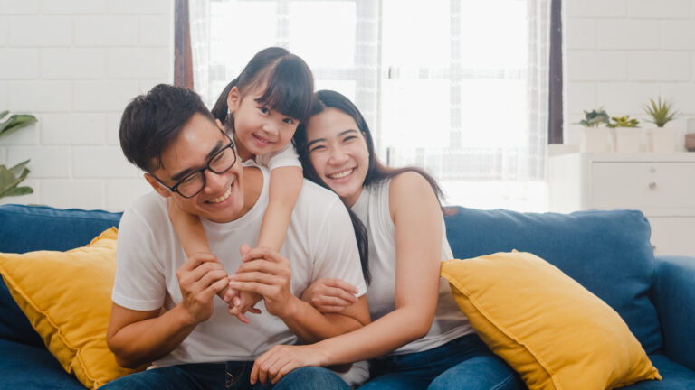 Happy family on a couch laughing