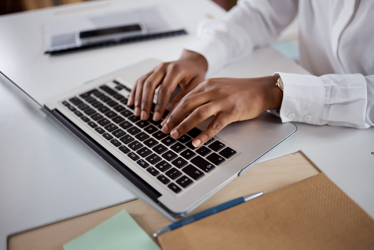 Shot of a business person using a laptop in a modern office