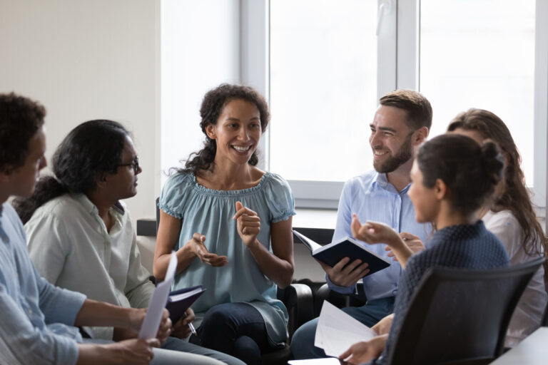 group of people sitting together and discussing